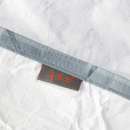 White rectangular camping sleeping bag made from DuPont TYVEK material showing 230cm length dimensions
