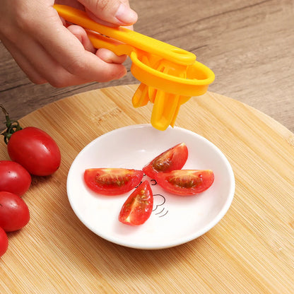 Manual tomato slicer with serrated knife for even dicing, available in red and yellow