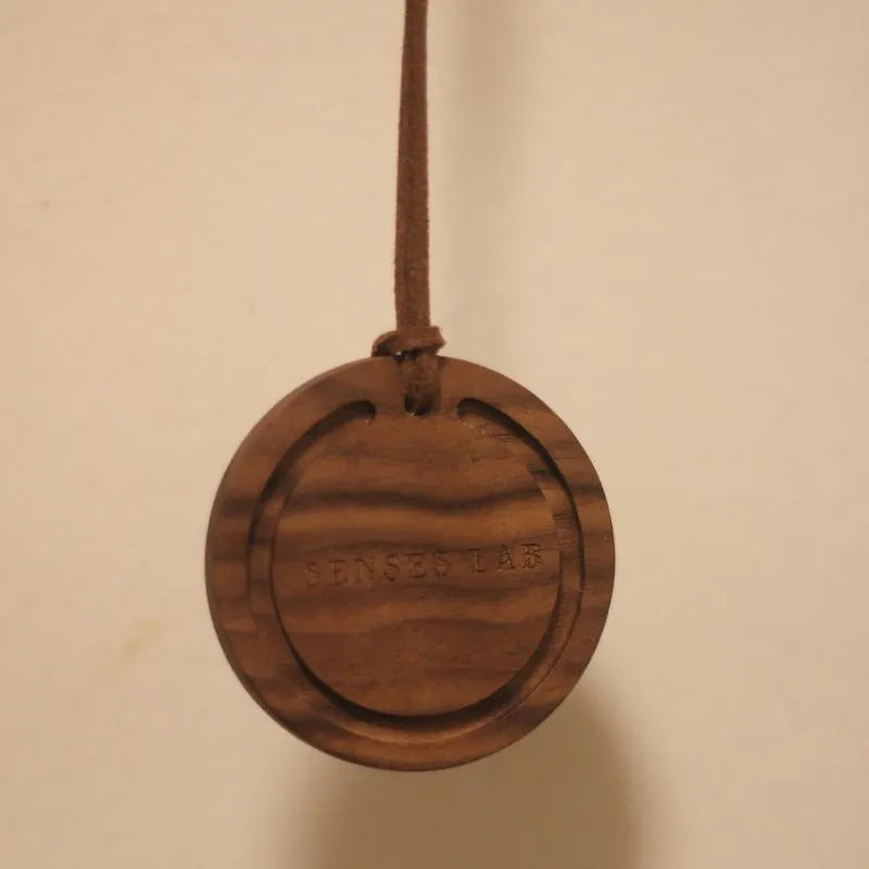 Round black walnut wood car air freshener pendant with jasmine green tea scent, 5cm diameter, brown colour variant