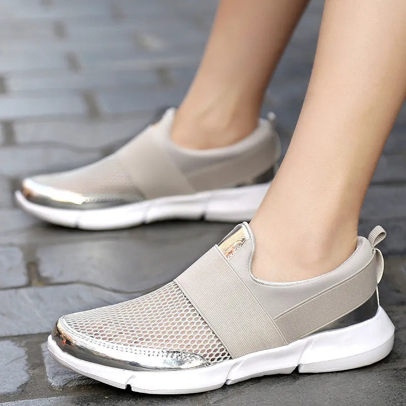Blue low-top women's mesh sneakers with a colour-matching pattern on a light background.