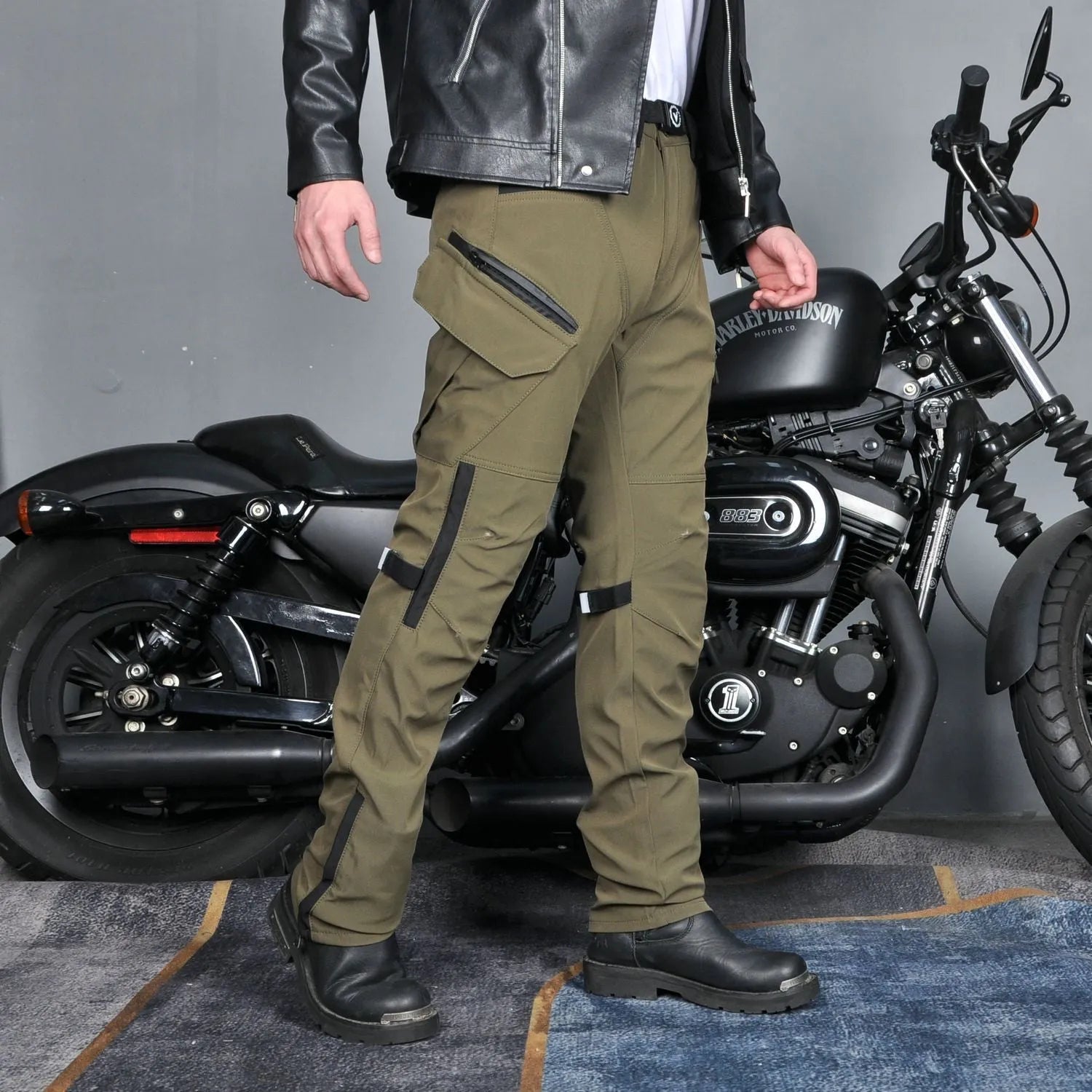 Men's waterproof black motorcycle cycling pants with detachable belt and protective knee pads on a mannequin.
