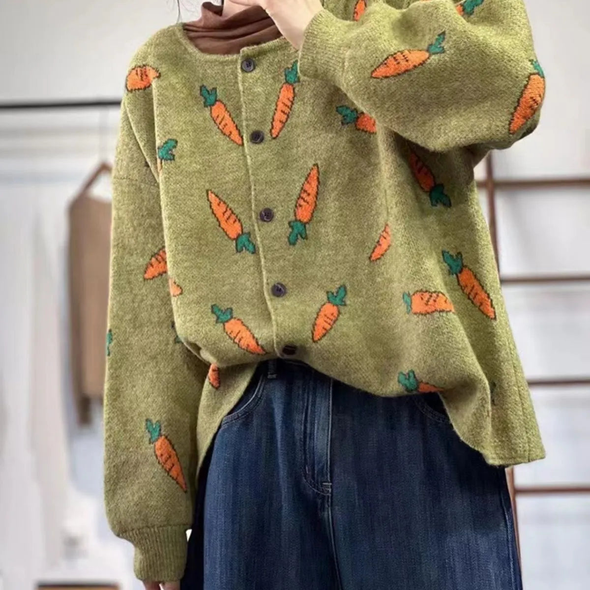 Loose grey cardigan with artistic multi-colour print, round neck, and regular sleeves.