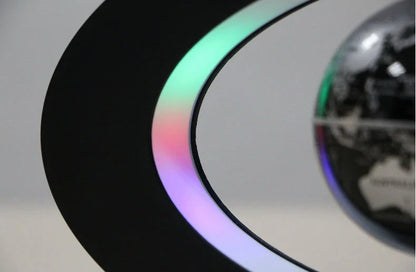 Magnetic levitation globe floating above base with LED light on