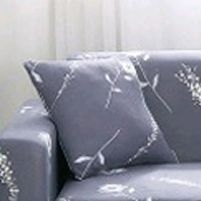 Printed stretchable sofa slipcover covering a three-seater sofa in a modern geometric pattern