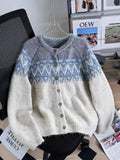 Women's loose beige jacquard knit coat sweater with long sleeves on a hanger
