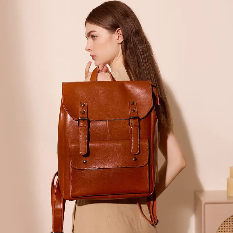 Women's structured backpack in genuine cowhide leather, shown in black, brown, and coffee colour options.