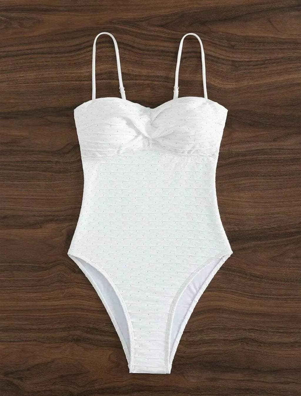 White women's one-piece swimsuit with sling design on mannequin