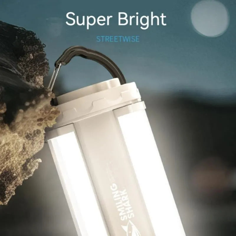 White cylindrical camping lamp with magnetic base and charging port showing LED light array