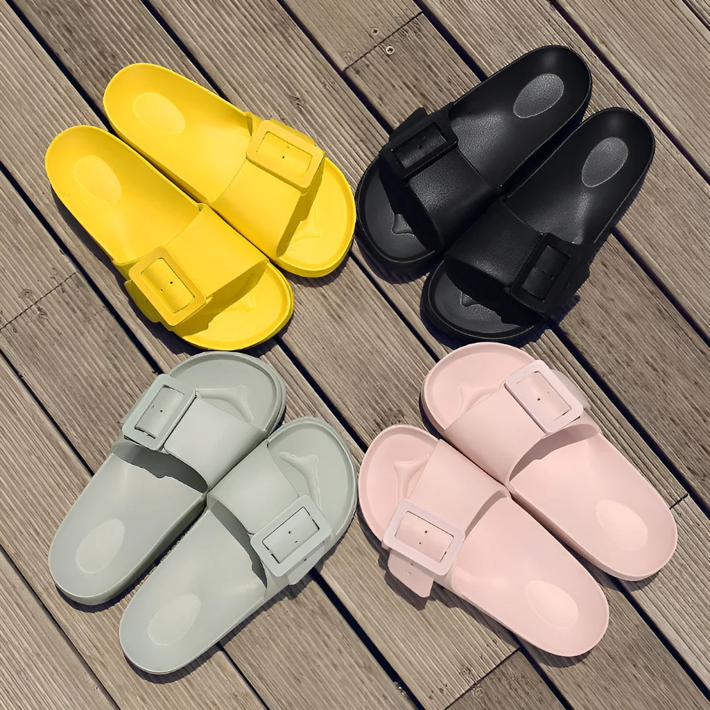 Women's grey blue buckle slipper with adjustable strap and soft EVA sole.