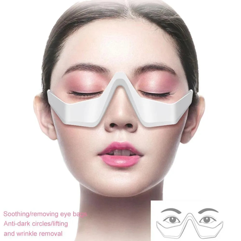 Pink and white micro-current eye massager with glasses-style frame on a grey background.