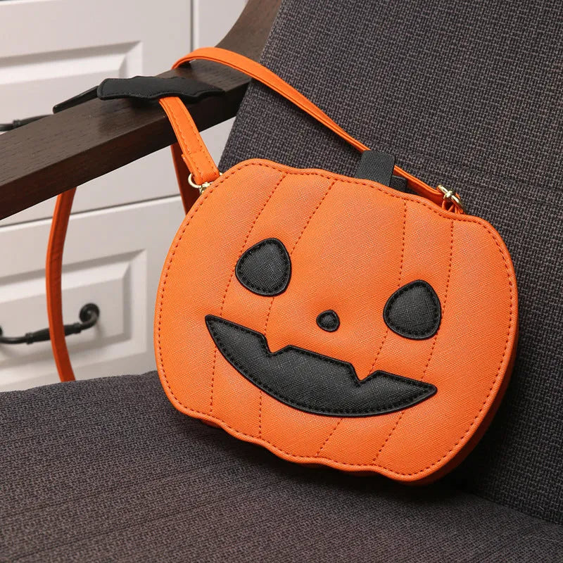Horizontal view of a PU crossbody bag with pumpkin and bat cartoon design in orange colour option.