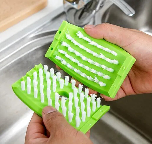 Blue kitchen cleaning brush with suction cup base for washing fruit, vegetables and cutlery.