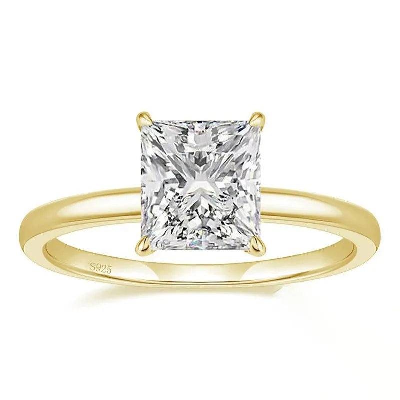 A polished geometric sterling silver ring for women on a grey background.