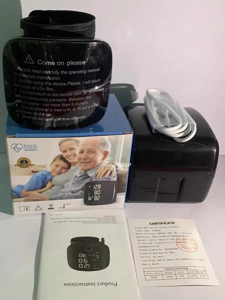 Black wrist-cuff blood pressure monitor with USB rechargeable cable on a table.