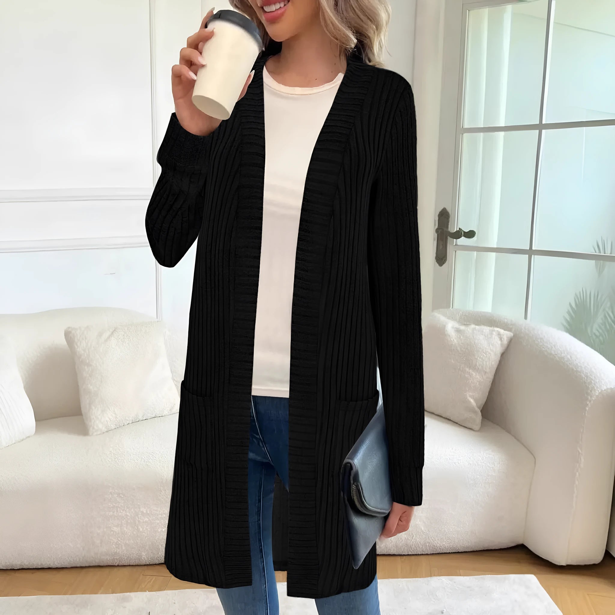 Black loose fit knitted cardigan jacket with long sleeves and side pockets on a mannequin.