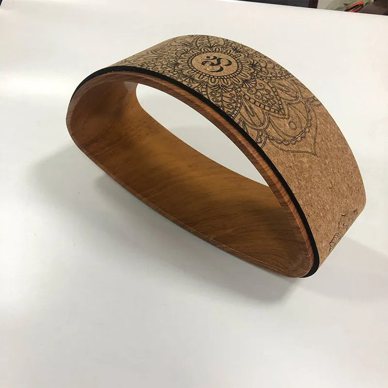 Half-round cork yoga wheel in black and wood grain for backbend and abdominal exercises