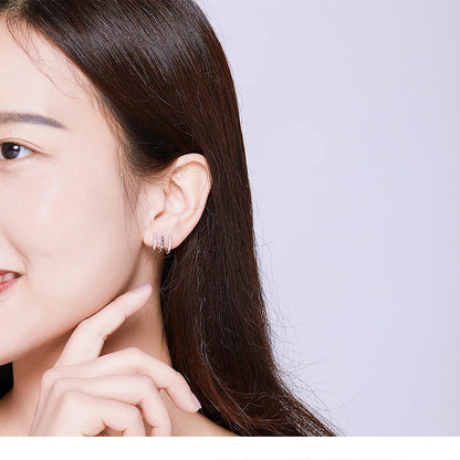 Three-layer sterling silver heart earrings with gem accents, handmade in Korean style