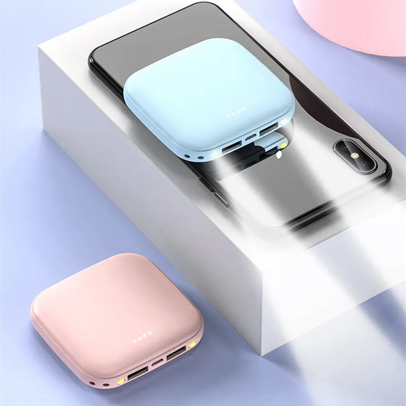 Portable 10000mAh power bank with multi-USB ports in black, white, blue, and pink colours