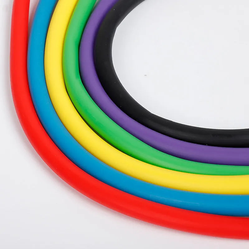 Five colour-coded latex resistance band pull ropes in black, blue, green, purple, red, and yellow on light background