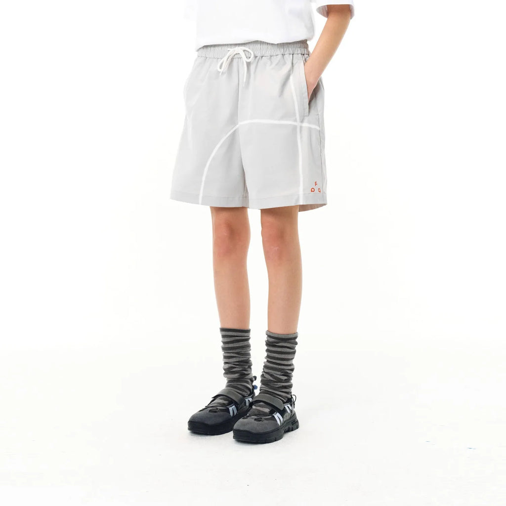 Man wearing retro grey drawstring beach shorts made from high elasticity polyester fabric.