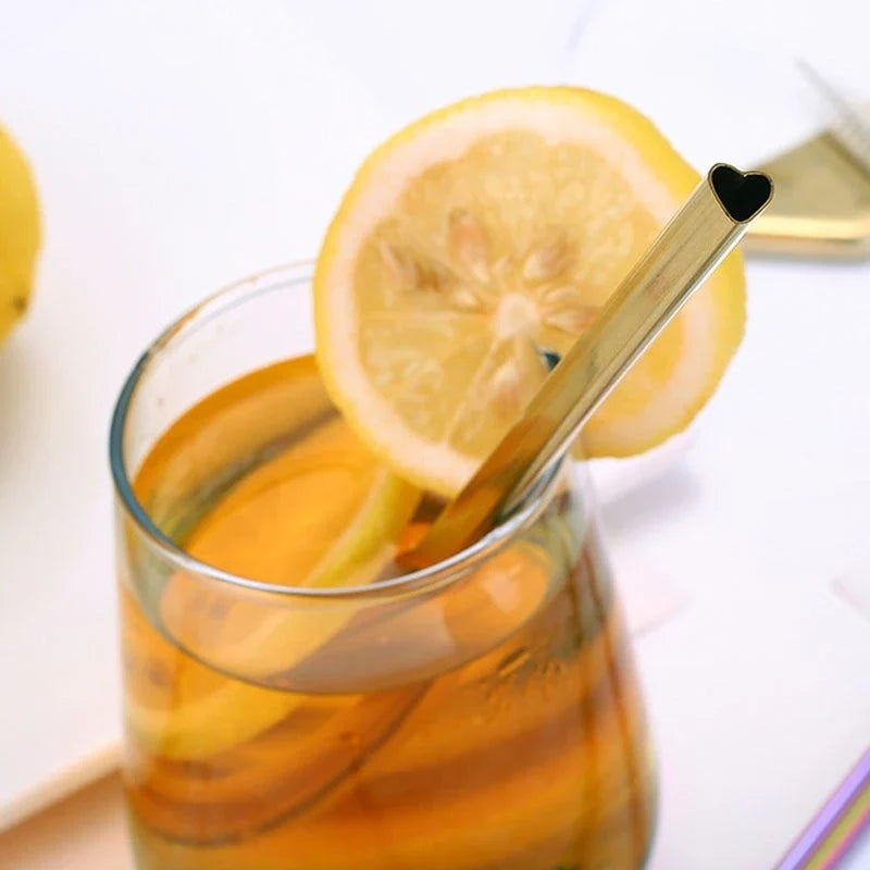 Reusable heart-shaped stainless steel straws in various colours with cleaning brush