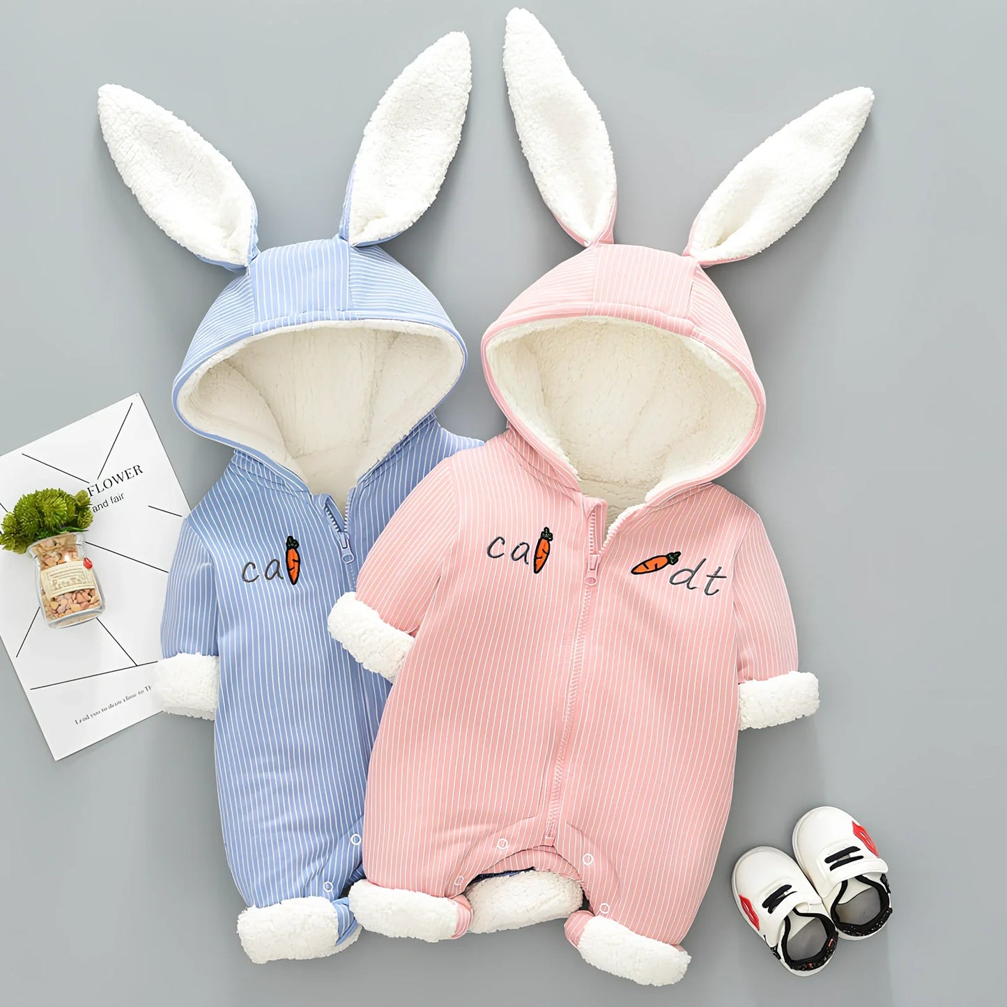 Baby winter jumpsuit with detachable hood in 95% cotton, available in pink and light blue colours