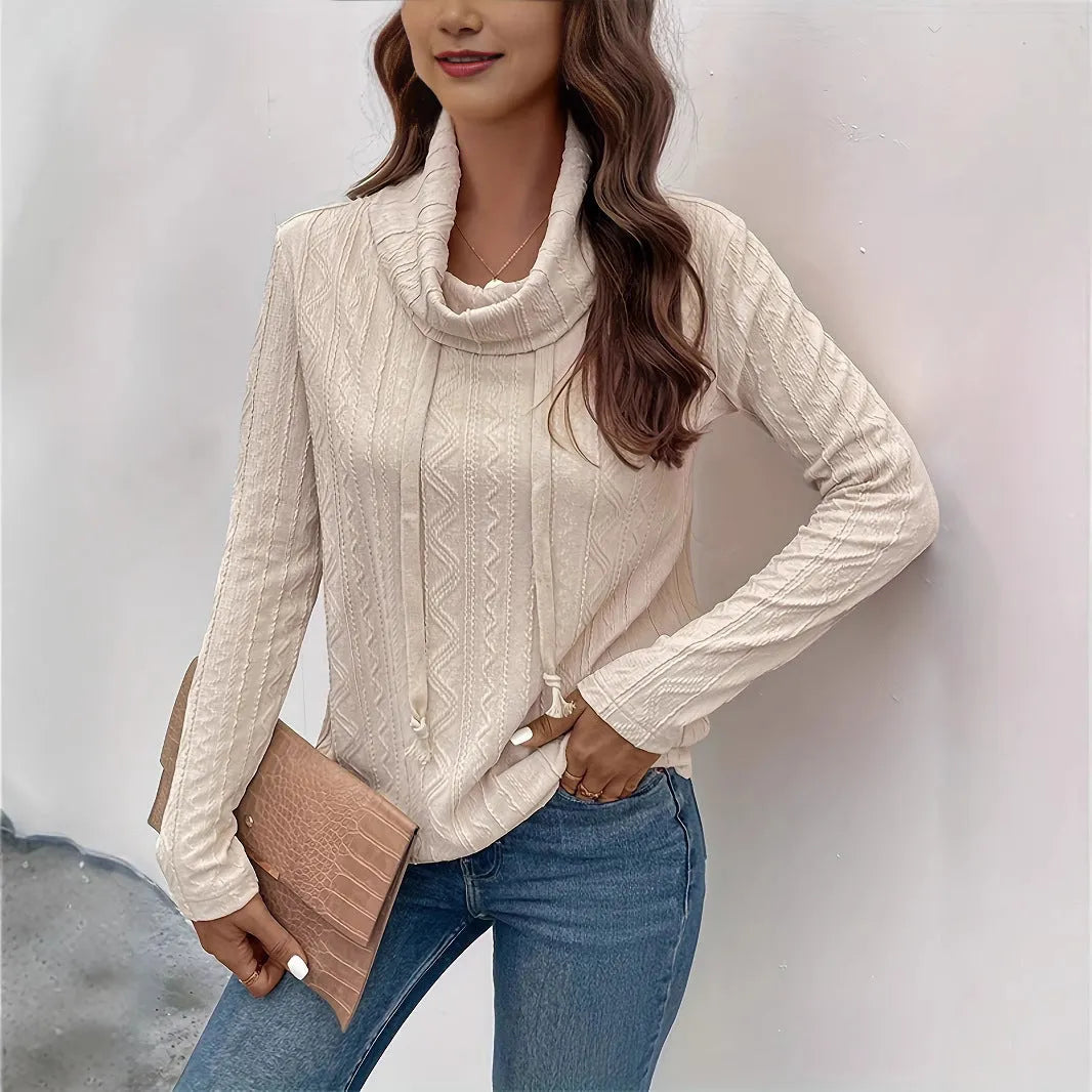 Apricot hooded pullover sweater with drawstring and long sleeves on hanger