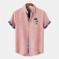 Man's light blue linen short-sleeve shirt with a colourful ocean fish pattern print on the front.