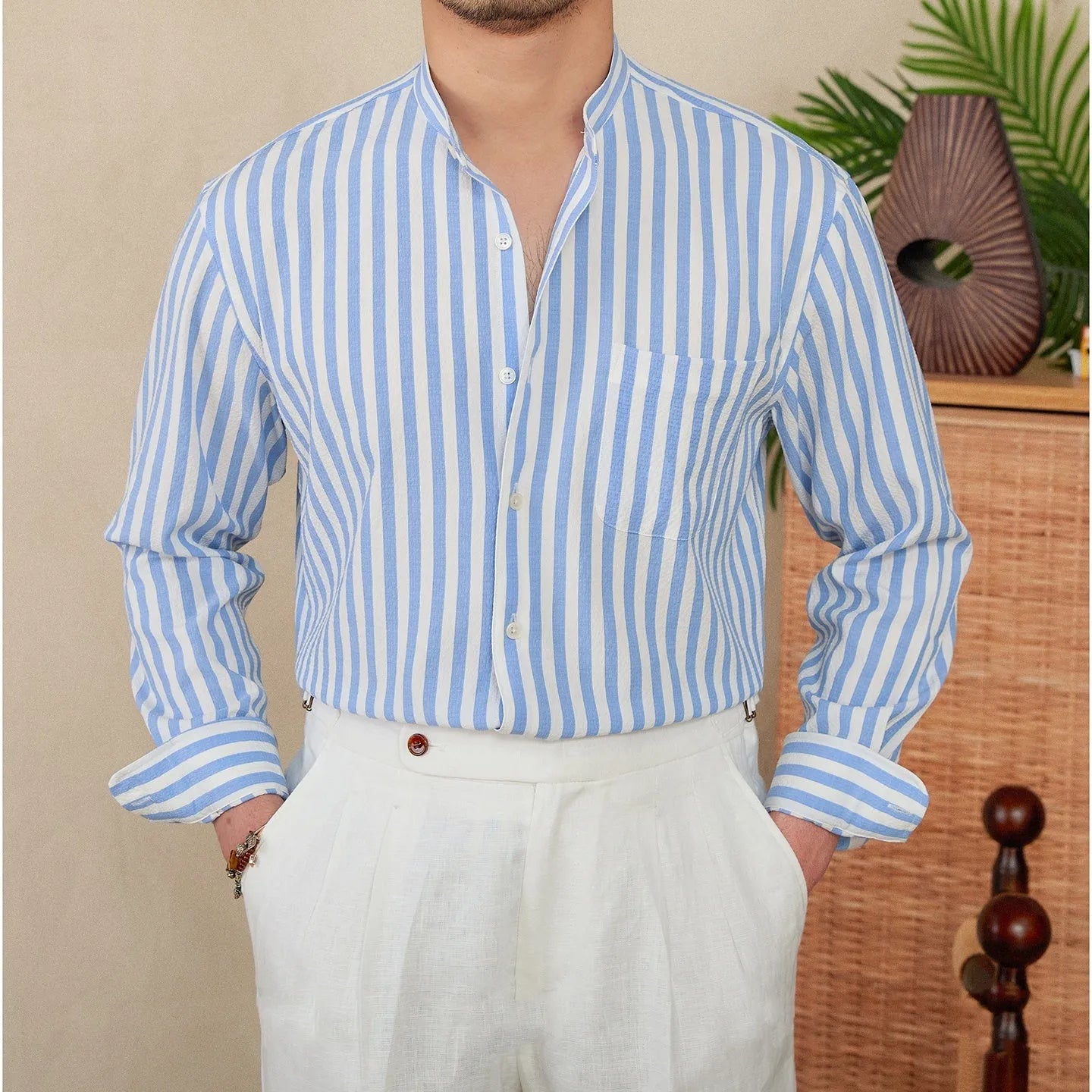 Blue and white seersucker striped long sleeve shirt with a loose lapel and baseball collar.