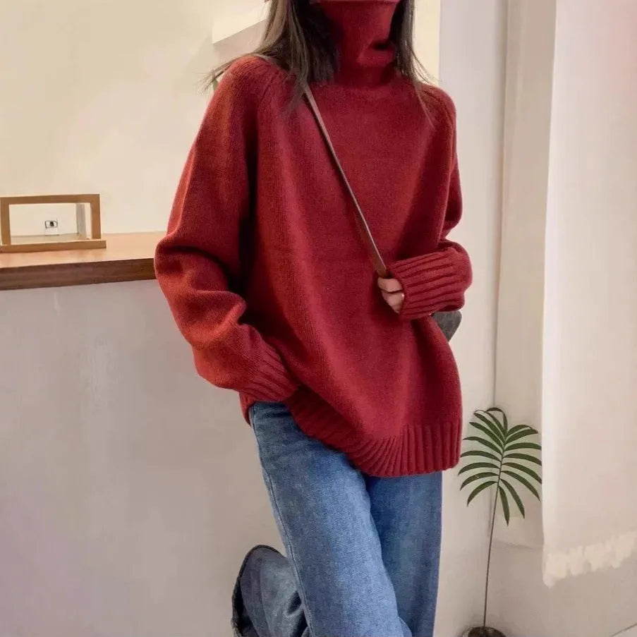 Women's loose thick grey turtleneck sweater with curling pile collar, casual pullover style.