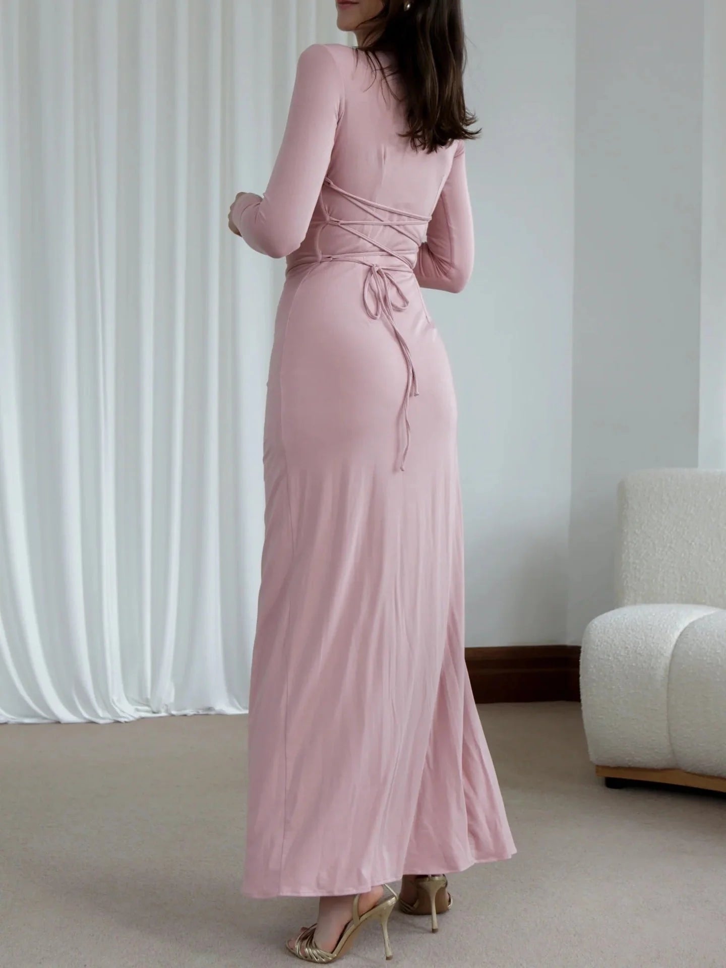 Slim-fitting asymmetric split dress in polyester-spandex blend, available in white, pink, black, and wine red.