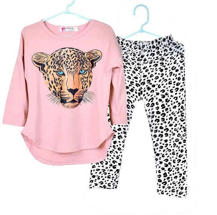 Two sets of children's casual summer pants suits in assorted colours on hangers.