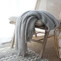 Nordic knitted bubble blanket in light grey on a modern sofa, 127x170cm polyester acrylic throw