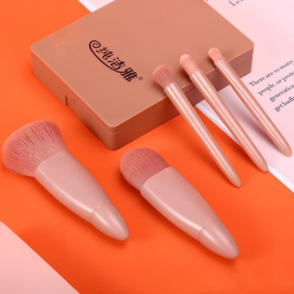 Pink 5-piece makeup brush set with mirror showing powder, foundation, blush, and eye brushes