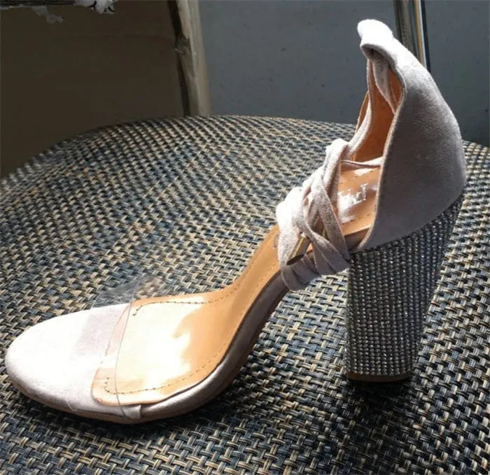 Black and gold pointed toe plastic stiletto high heels for women.