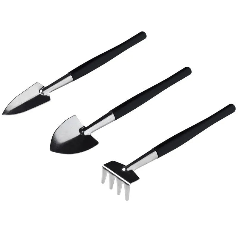 Black plastic and metal 15-piece mini succulent garden tool set displayed with shovel, tweezers, scissors, watering bottle, and cushion.