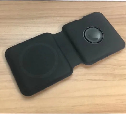 White foldable magnetic wireless charging dock showing two phones charging simultaneously at an angle.