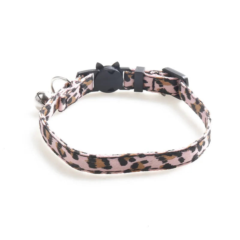 Brown cloth cat collar with attached bell on a white background
