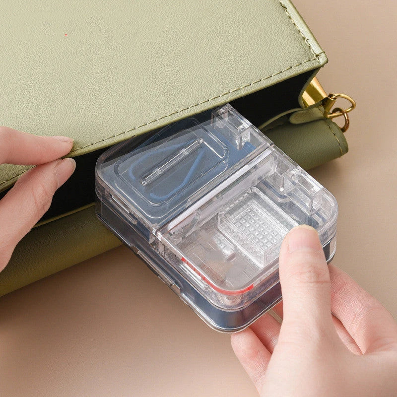 Portable mini medicine storage box with tablet cutter in red, green, blue, and white