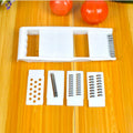 White home kitchen multifunctional grater with stainless steel blade and hand guard on white background