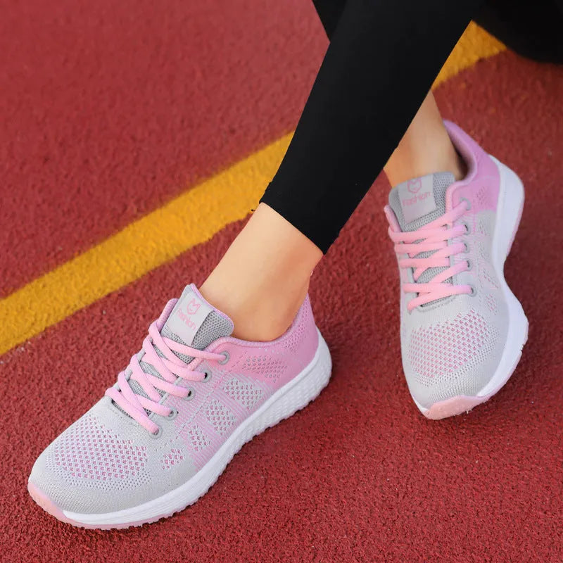 Women's white high-top casual shoes with cross-bind straps and a lace-up back closure on a flat sole.