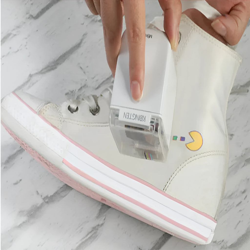 White Mbrush portable colour handheld inkjet printer on a surface with its compact dimensions 72x51x68mm visible