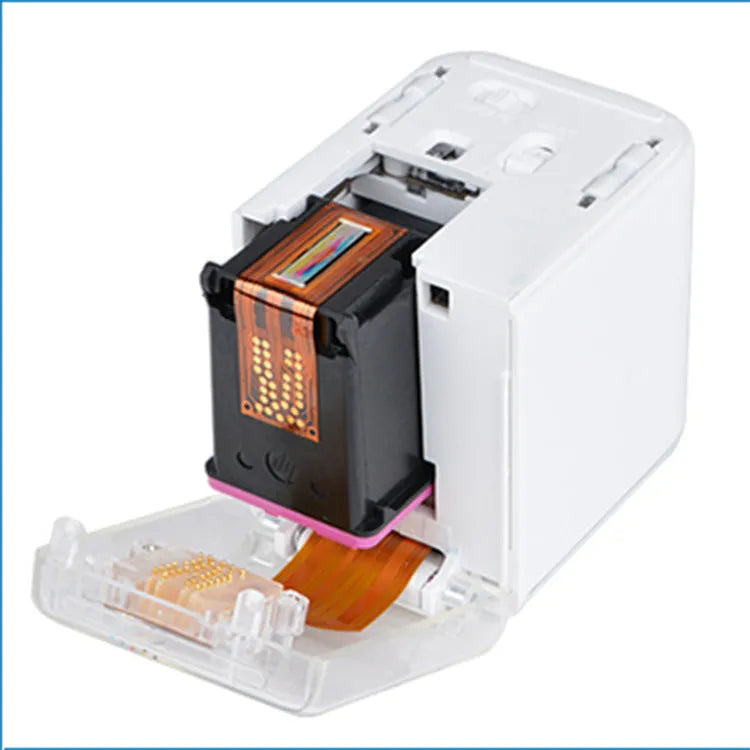 White Mbrush portable colour handheld inkjet printer on a surface with its compact dimensions 72x51x68mm visible
