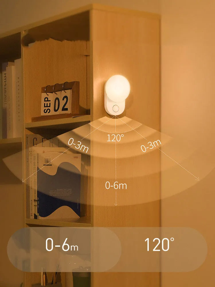 White Baseus Full Moon rechargeable LED sensor night light on a surface.