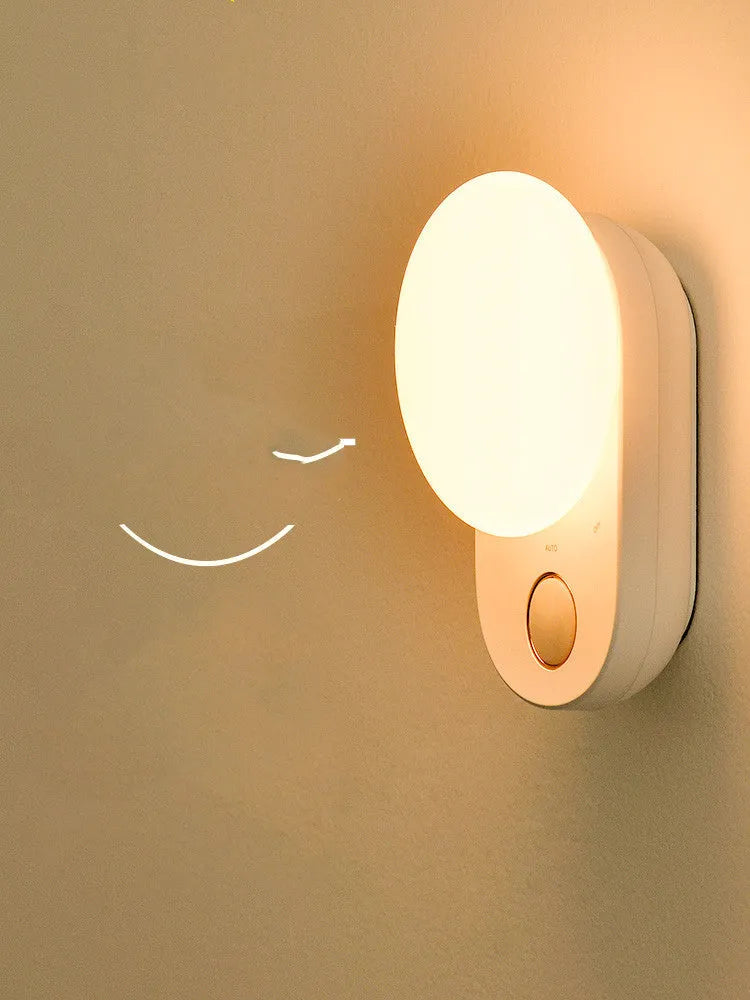 White Baseus Full Moon rechargeable LED sensor night light on a surface.