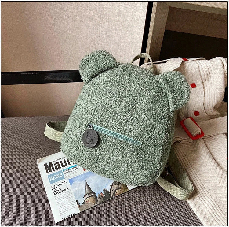 Cute, bear-shaped backpack made of soft, fleece material in various colors for casual travel and daily use