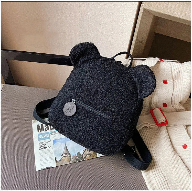 Cute, bear-shaped backpack made of soft, fleece material in various colors for casual travel and daily use