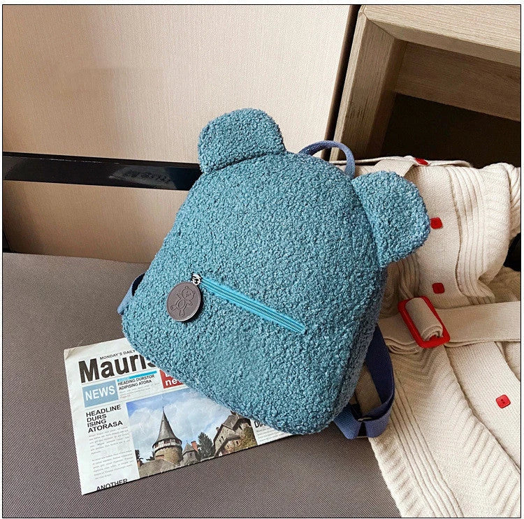 Cute, bear-shaped backpack made of soft, fleece material in various colors for casual travel and daily use