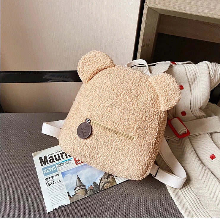 Cute, bear-shaped backpack made of soft, fleece material in various colors for casual travel and daily use