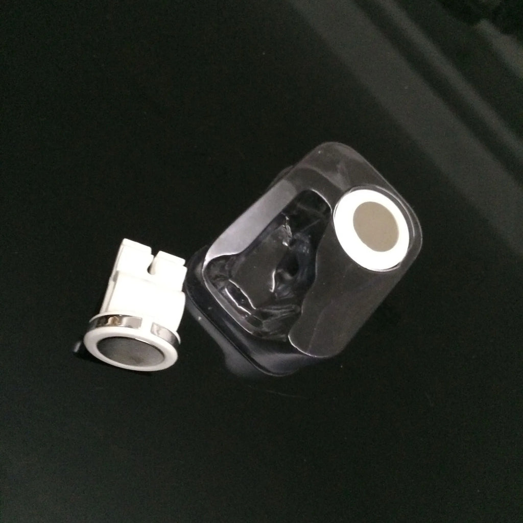 Mini white magnetic car phone holder clipped on car air vent showing compact 3cm size
